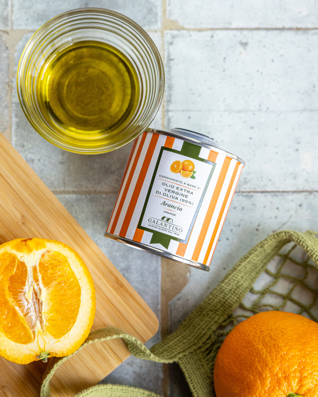 A can of premium orange-flavored extra virgin olive oil, perfect for gourmet cooking and enhancing your exceptional curated pantry collection.