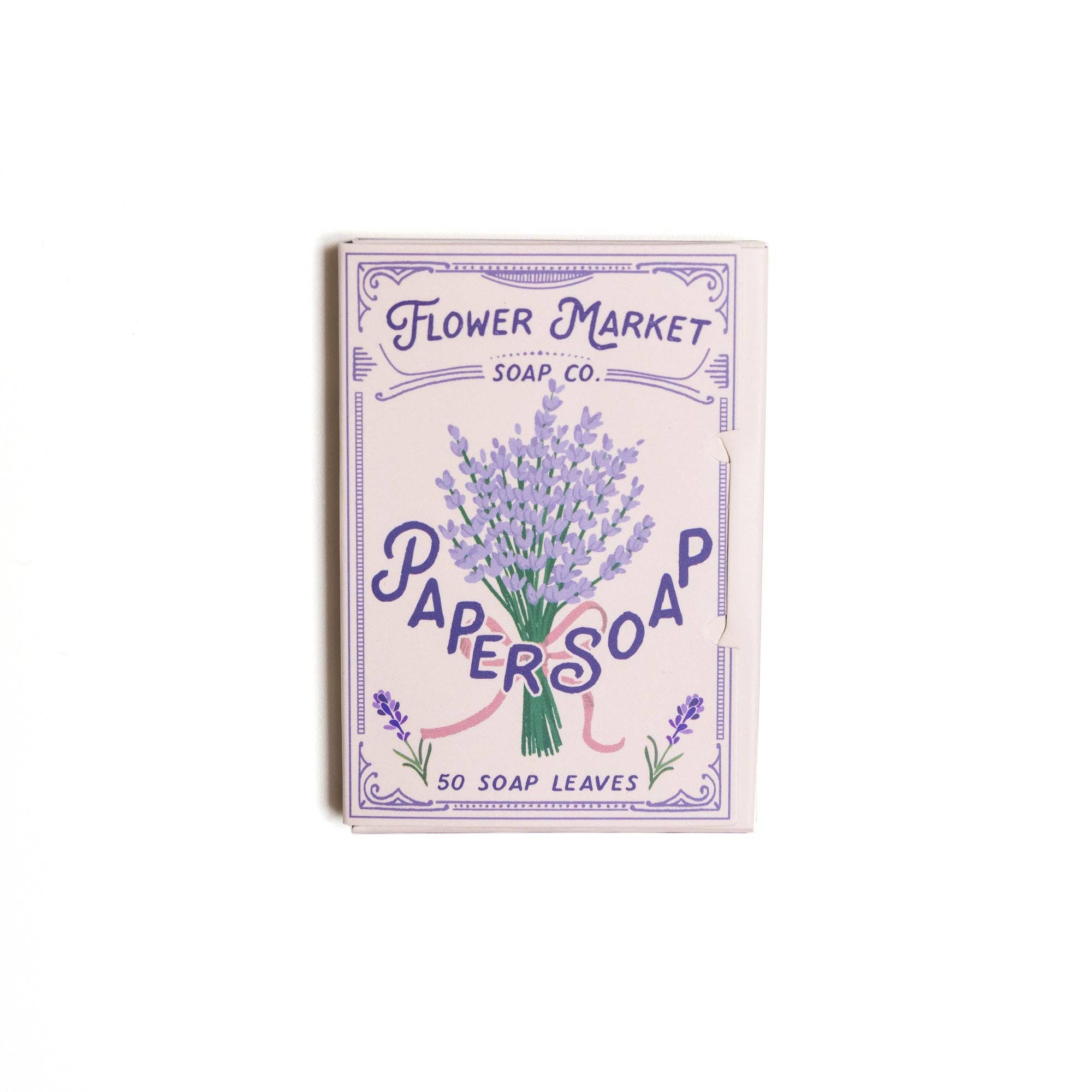 Lavender paper soap sheets box with purple floral design, open lid showing soap sheets, eco-friendly packaging for travel use