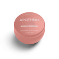 Round pink candle container with white text reading 'Sea Salt Grapefruit' and 'Hand-Poured Scented Candle' in a minimalistic design