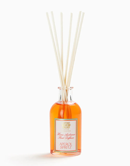 Aperol Spritz fragrance diffuser in a clear glass bottle with orange liquid and white reed sticks, ideal for home fragrance decor