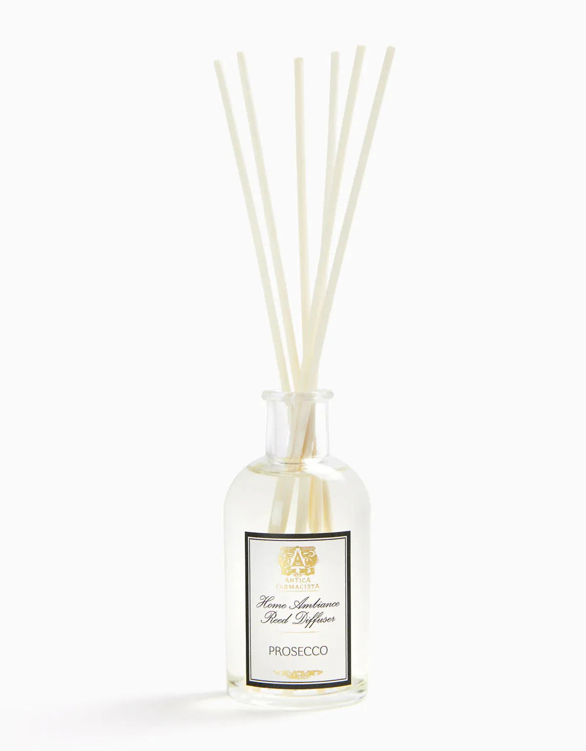 Clear glass bottle of Prosecco diffuser fragrance with white reed sticks, elegant label, and subtle gold accents for home decor
