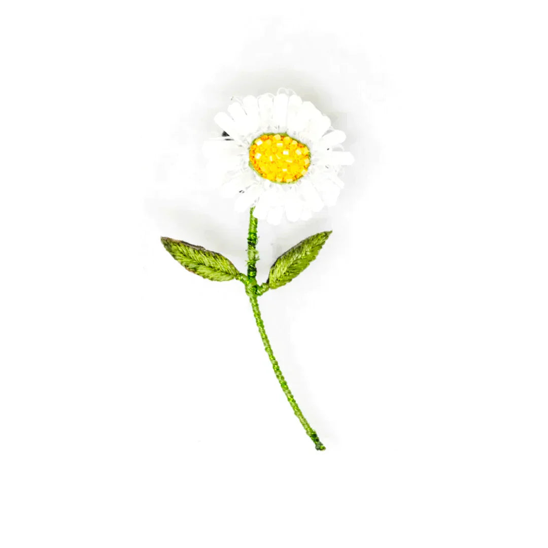 Handcrafted artisan daisy brooch pin with white petals and yellow center, detailed embroidery on a white background